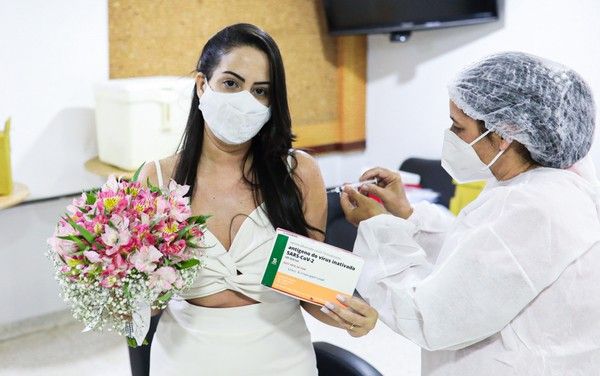 Enfermeira é vacinada contra Covid vestida de noiva